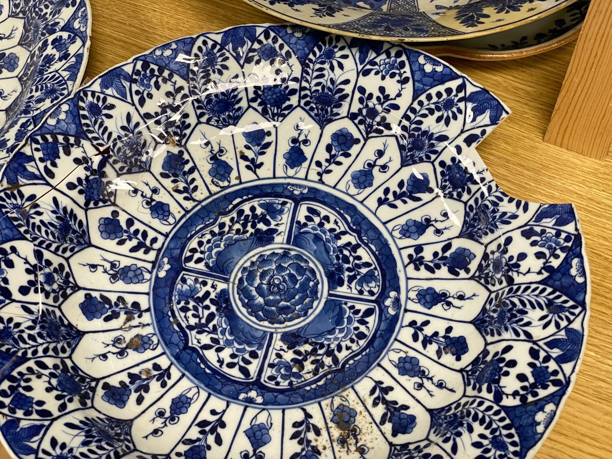 Four Chinese Kangxi period blue and white dishes and a Qianlong blue and white dish